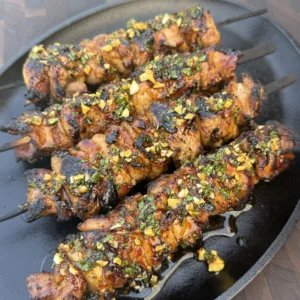 hot honey lemon chicken skewers on a plate