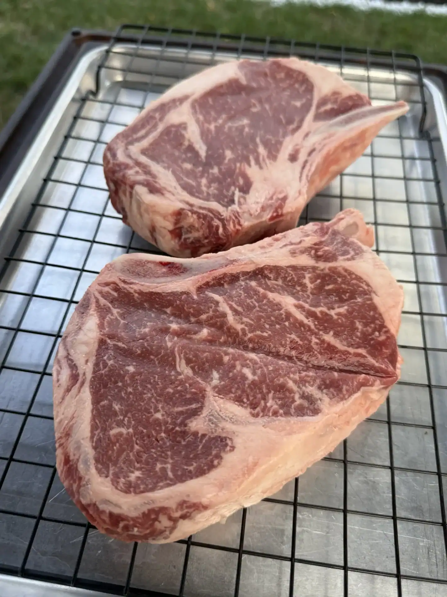 perfect bone in ribeyes on the resting rack