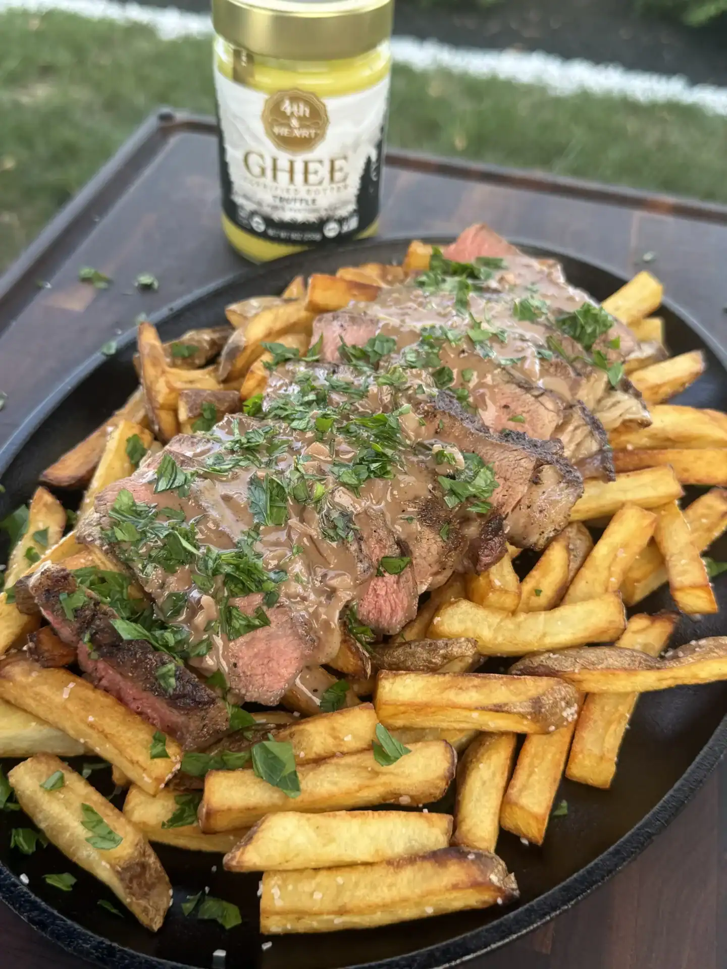 up close of the final loaded fries with black truffle ghee sauce