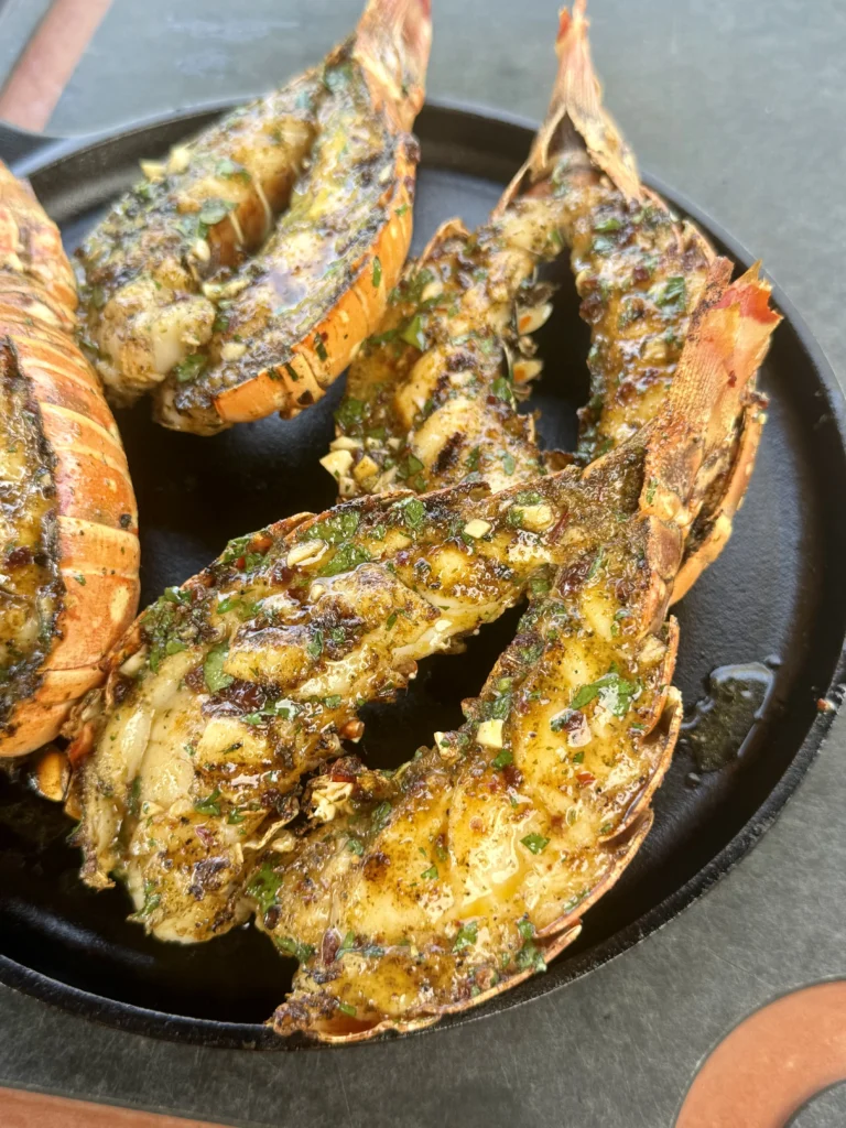 4 lobster tails on the black plate
