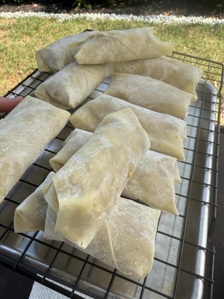egg rolls on the resting rack before frying