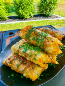 texas twinkie egg rolls on a black plate