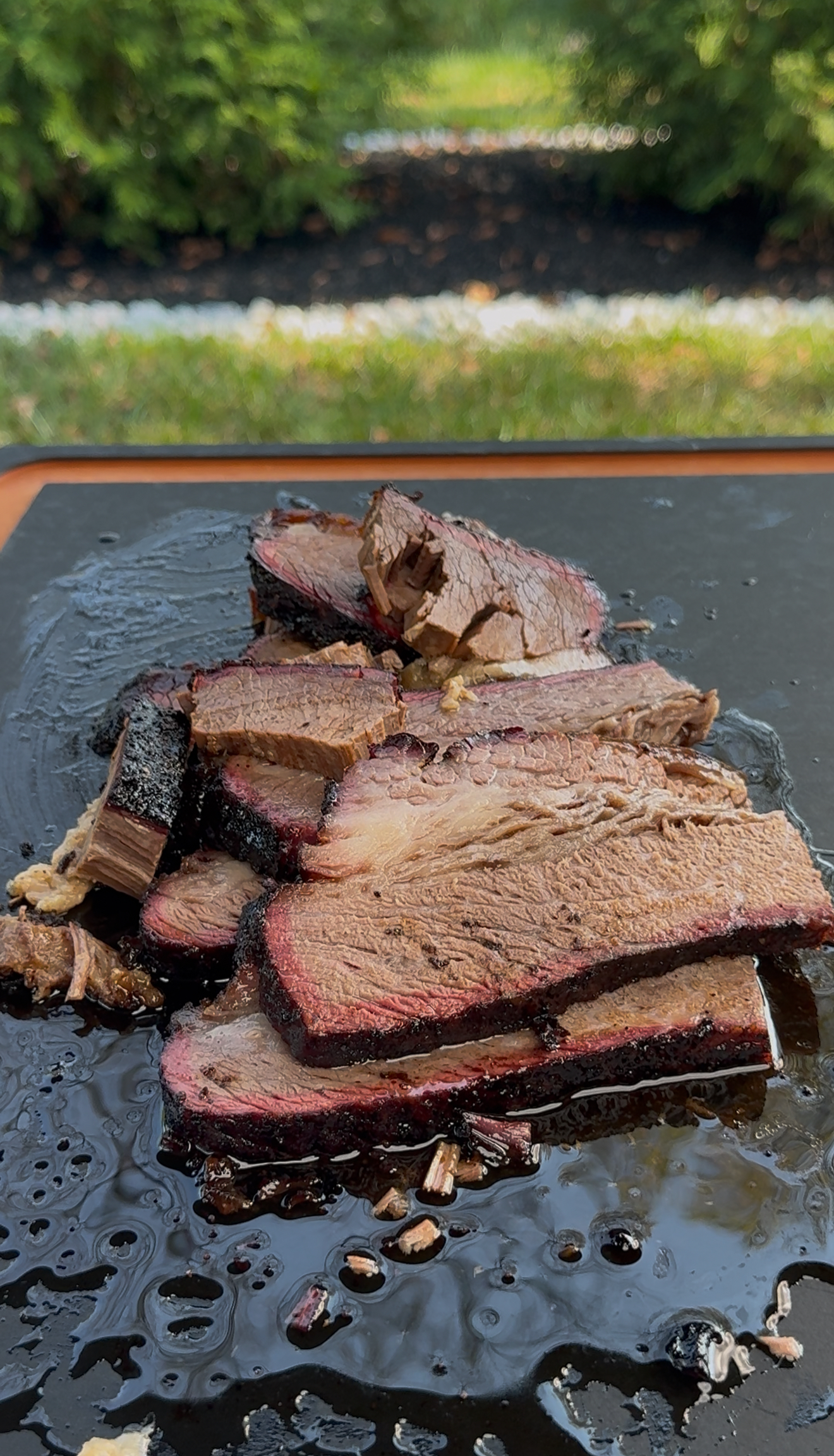 Cut up brisket on the cutting board showing flat and point sections