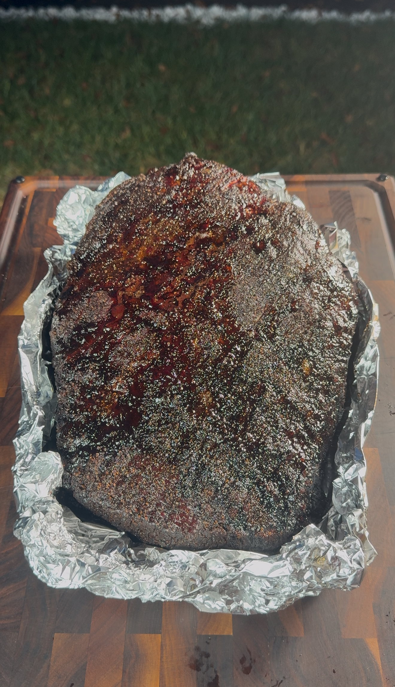 Brisket being unwrapped from butcher paper showing tender juicy meat