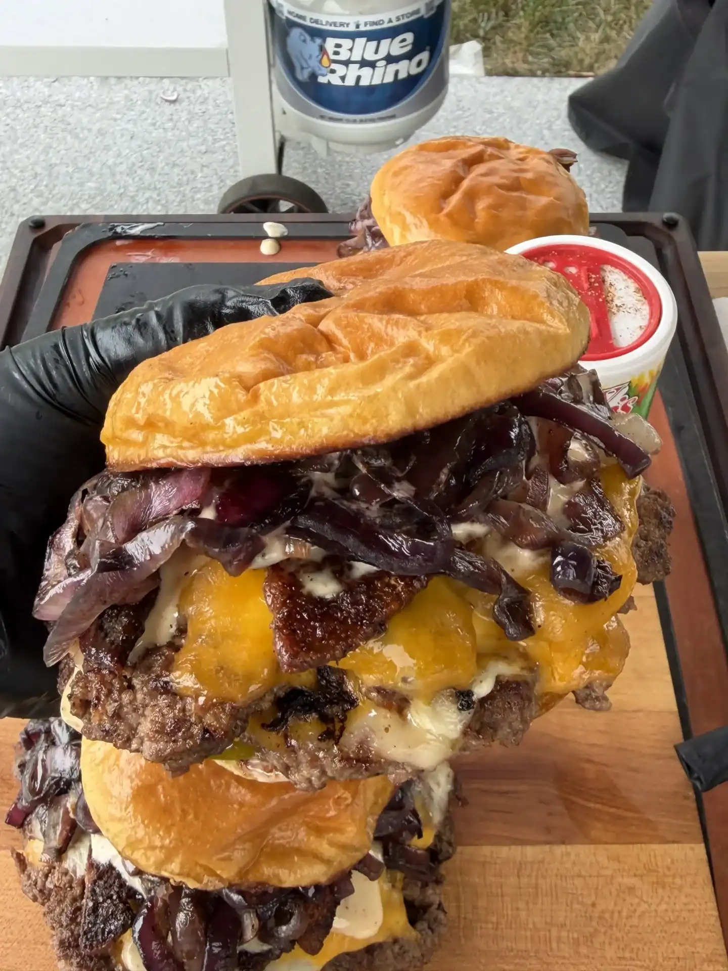 cajun smash burger being held in a hand