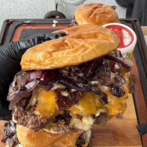 cajun smash burger being held in a hand