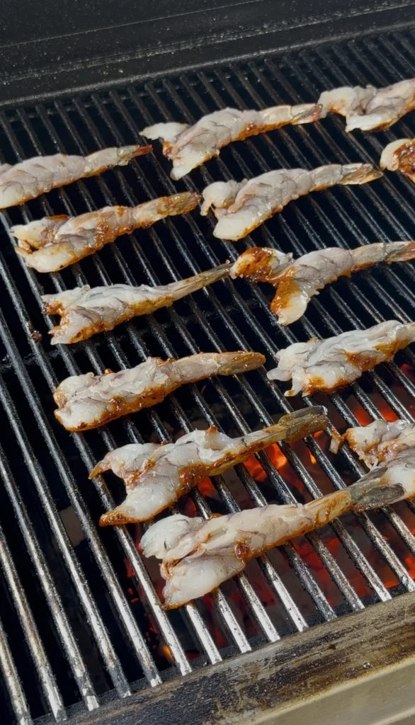 adding shrimp to the grill