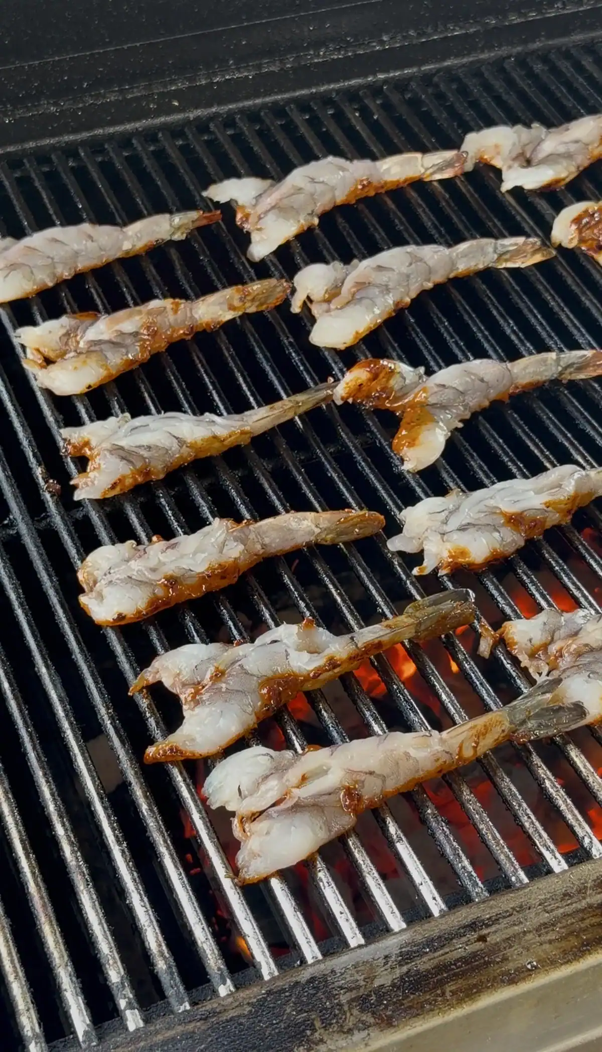 adding shrimp to the grill