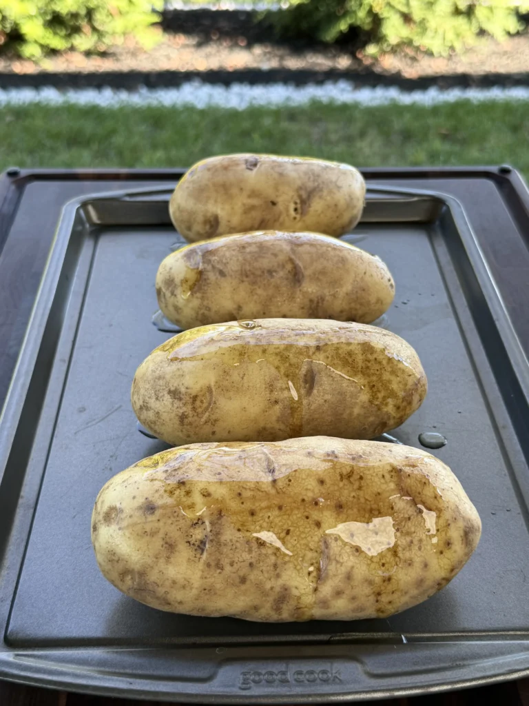 potatoes on a pan ready to be baked