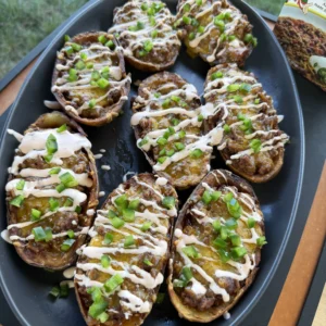 finished potato skins on a black plate
