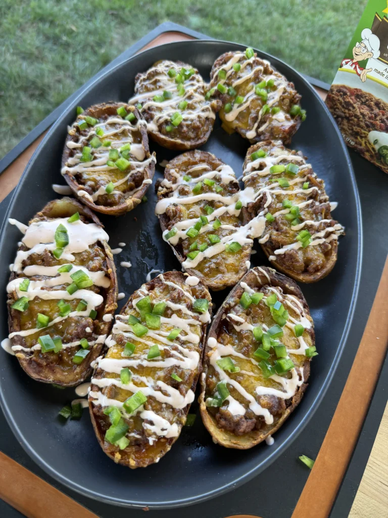 finished potato skins on a black plate