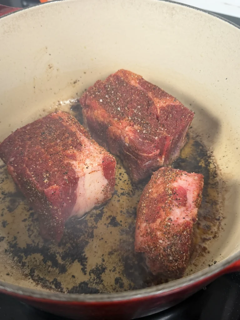 seared chuck roast in a dutch oven