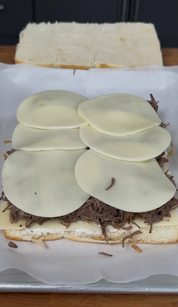 more cheese on top of the shredded beef