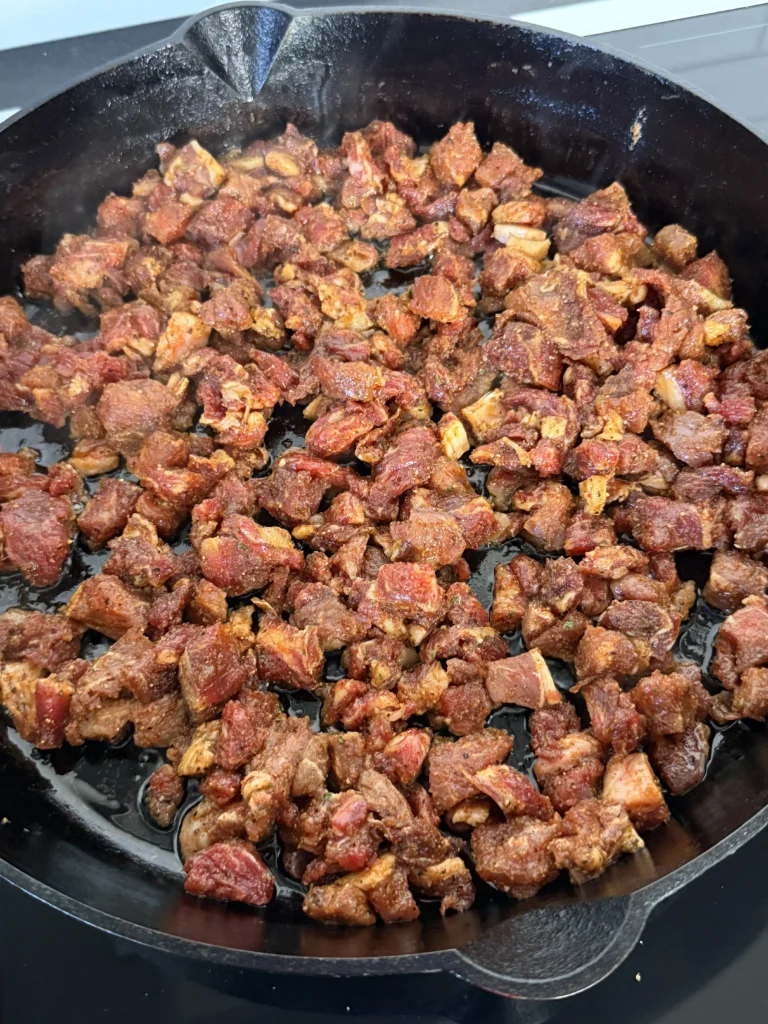 cooking ribeye steaks in the cast iron