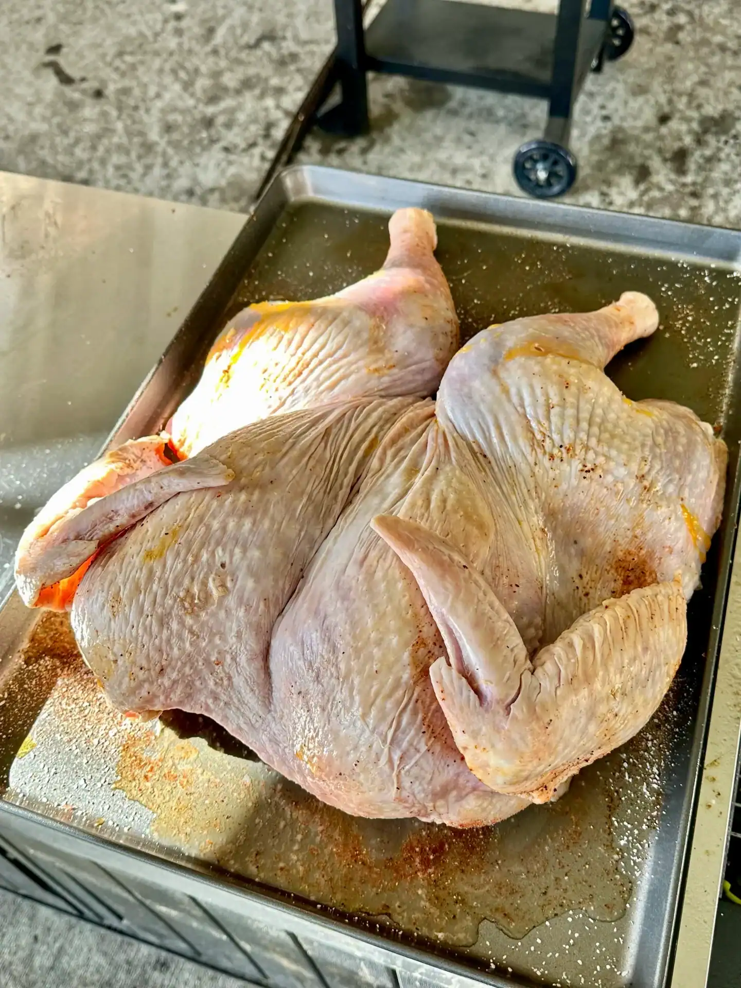 raw turkey sitting on the cutting board