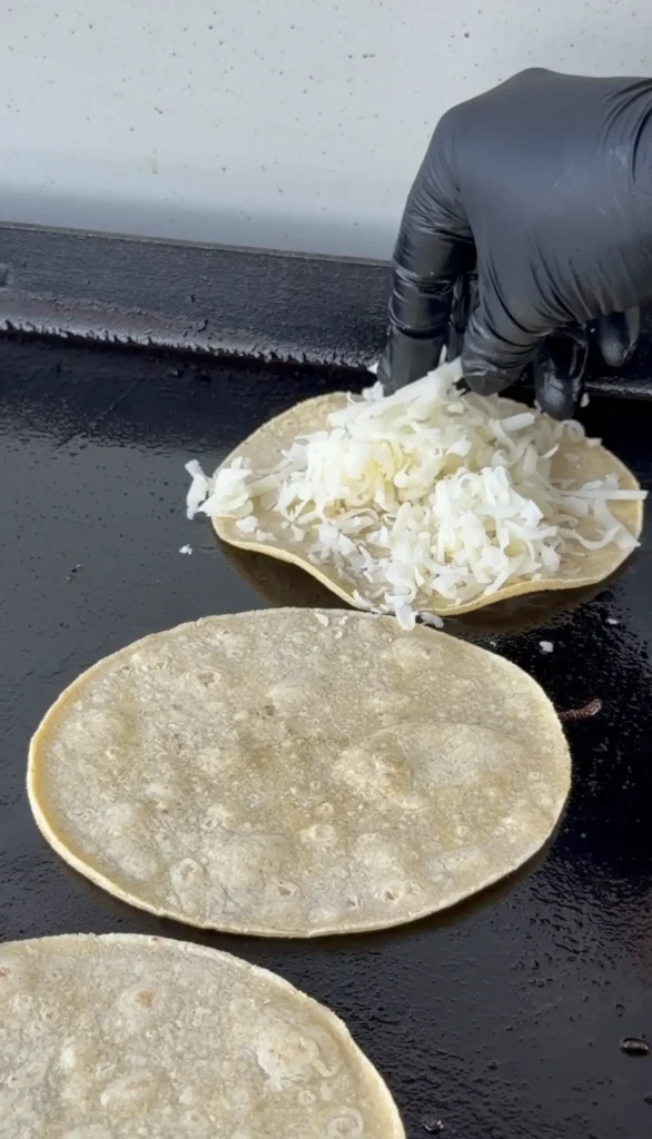 adding cheese to the tortillas