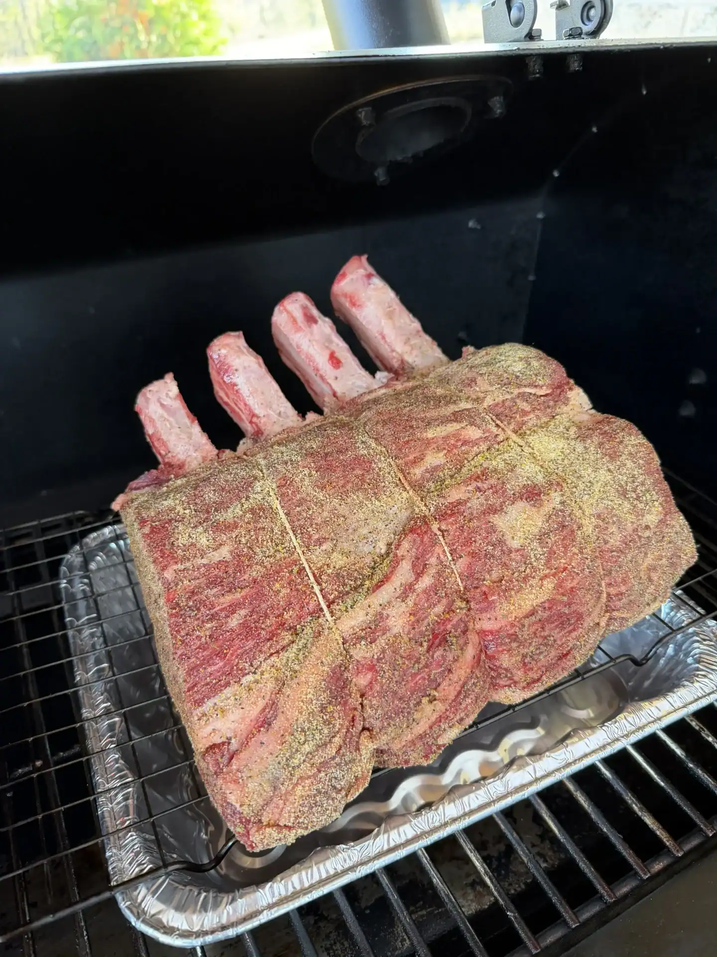pellet smoker with a prime rib on it