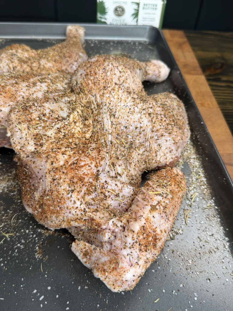 seasoned turkey on the metal tray