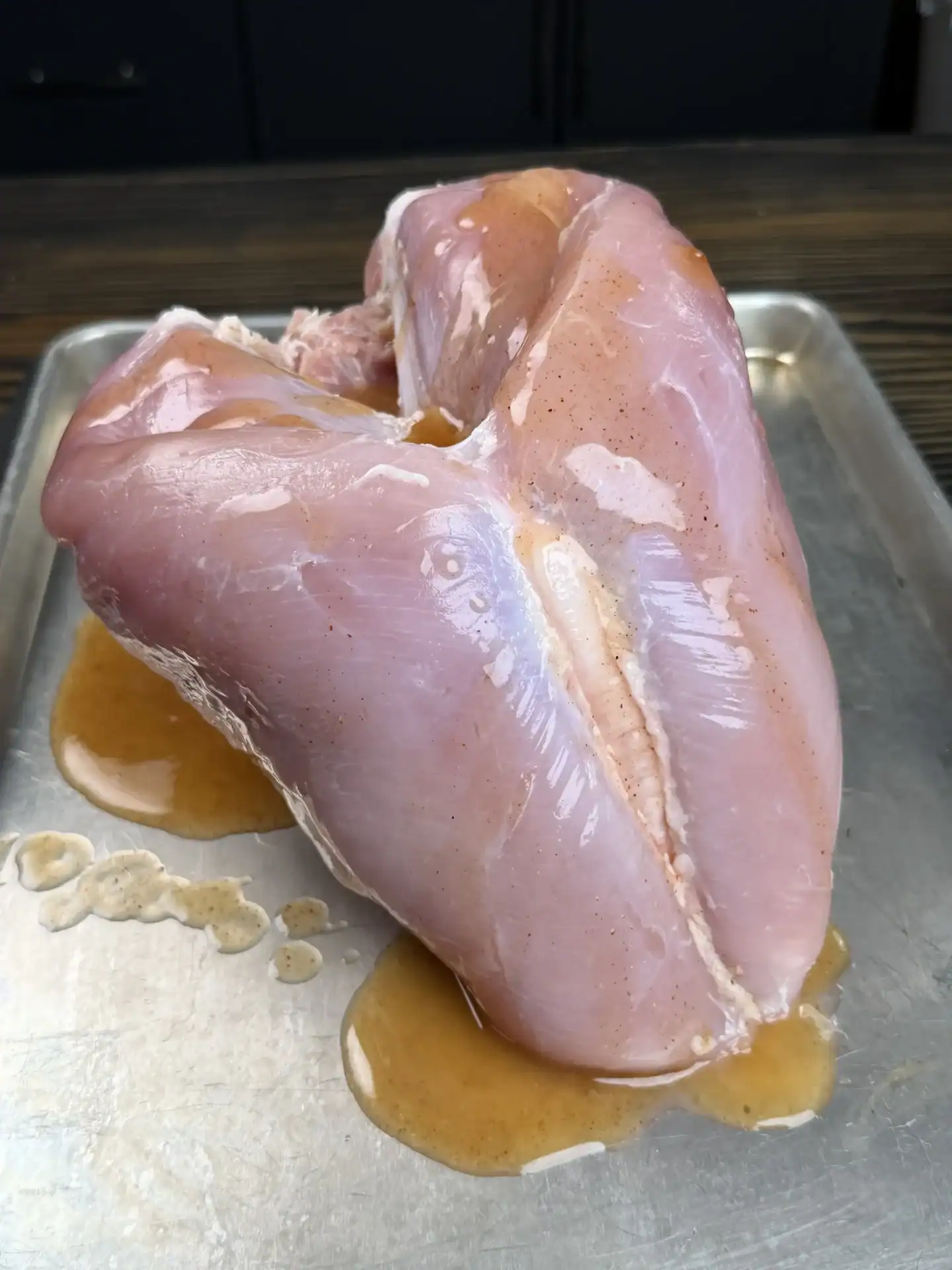 brined turkey breast on a cookie sheet.