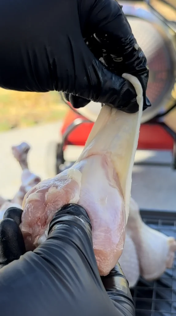 pulling the skin off the chicken lollipops