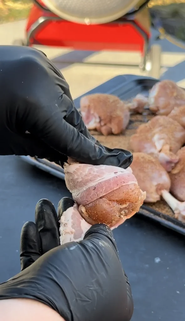 chicken lollipop being wrapped in bacon