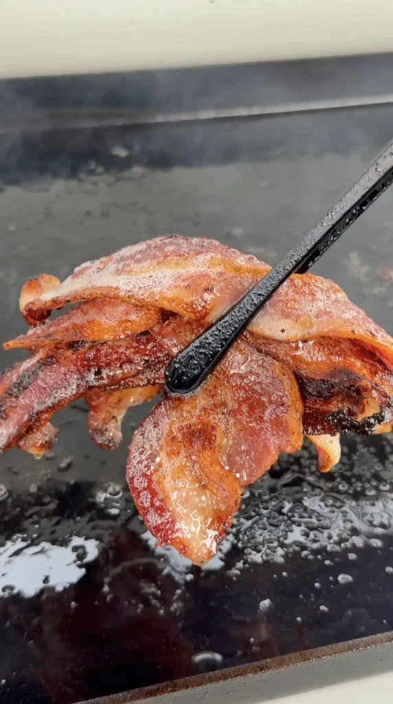 cooked bacon on the griddle