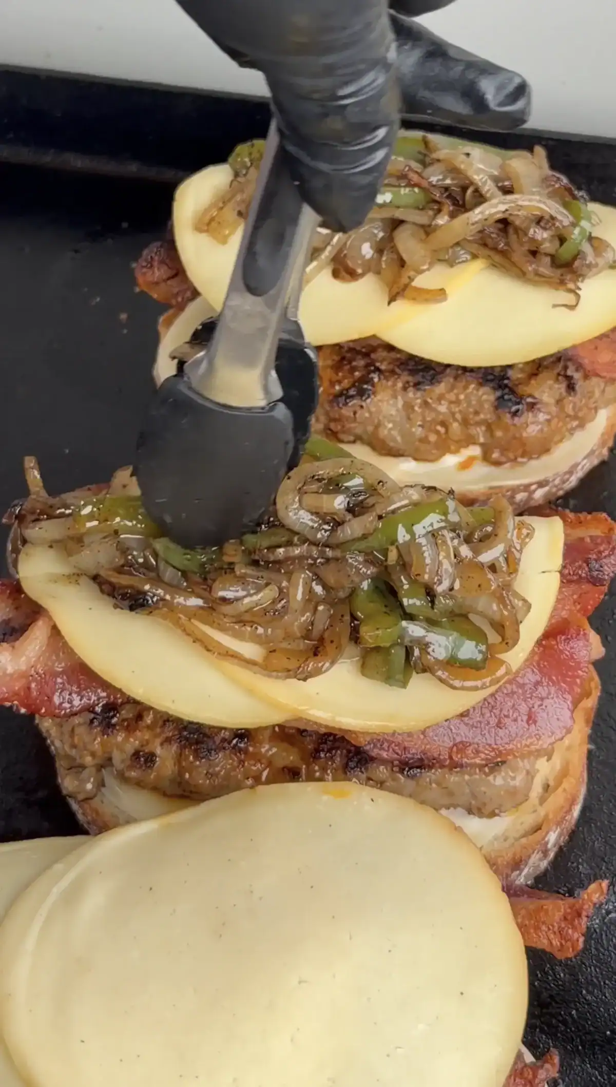 griddled breakfast sandwich being assembled