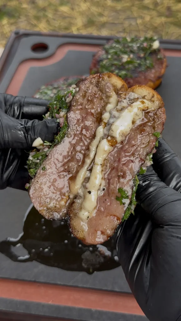 sausage and cheese stuffed bread on the cutting board