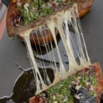 sausage stuffed bread recipe being pulled apart