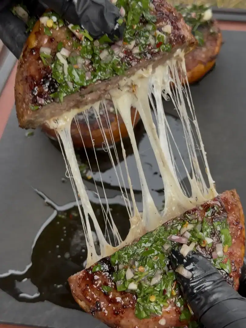 sausage stuffed bread recipe being pulled apart