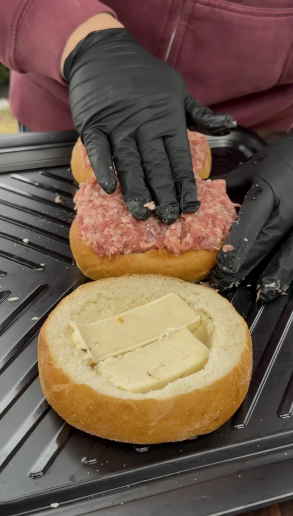 bread with the sausage being placed