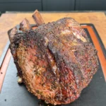 smoked prime rib on a black cutting board