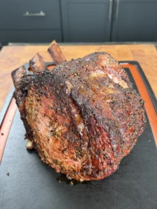 smoked prime rib on a black cutting board