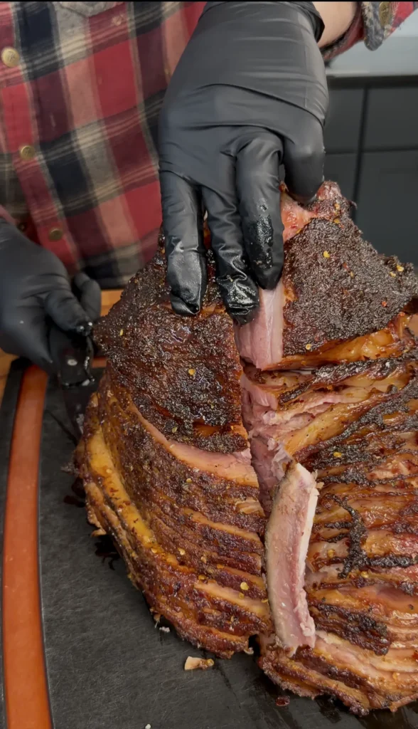 sliced christmas ham on a cutting board
