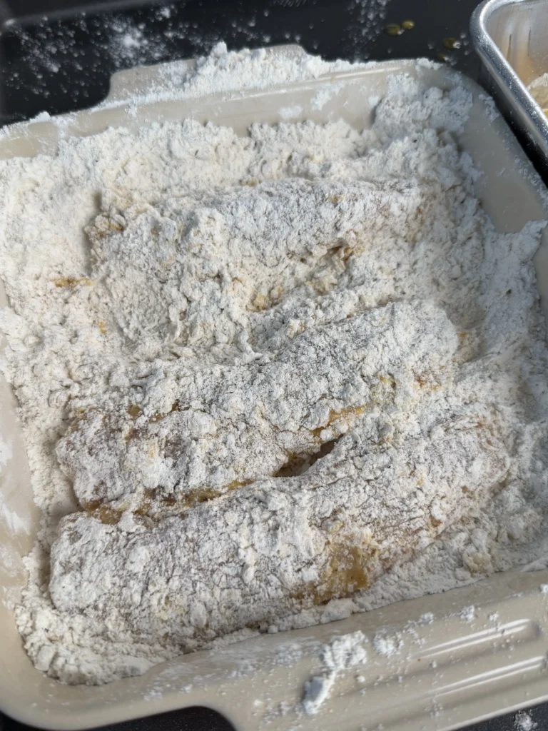breaded chicken tenders in a pan 