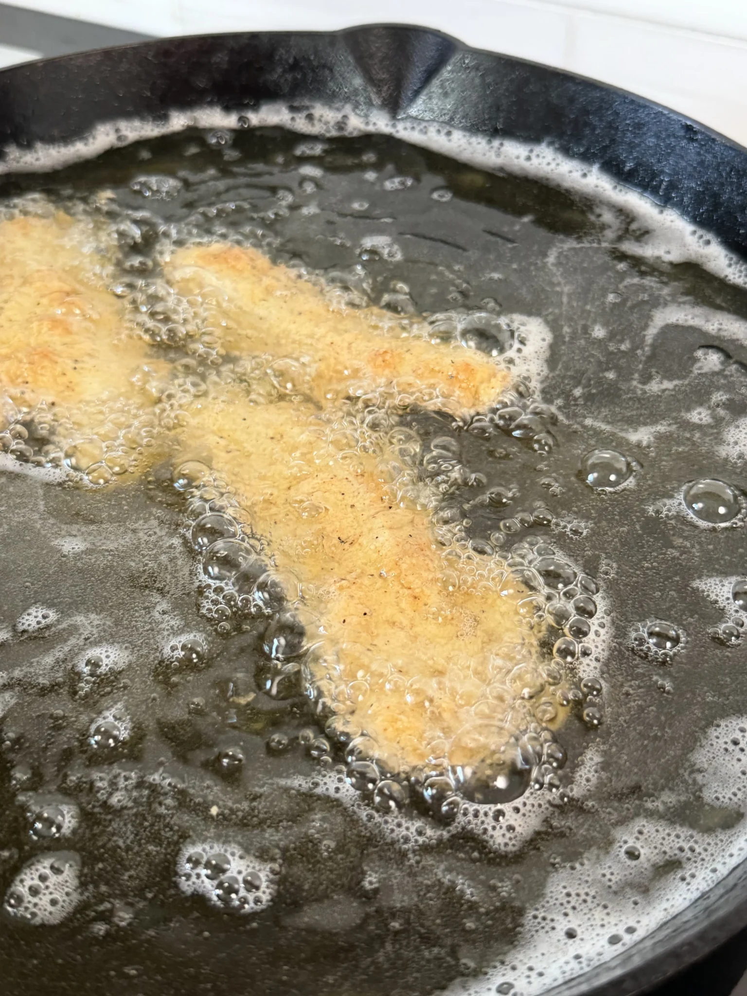 fried chicken tenders in hot oil