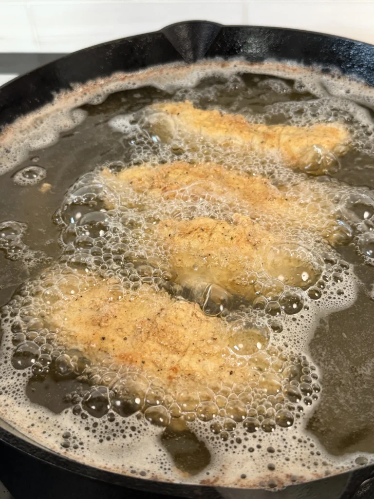 3 chicken tenders in the hot oil