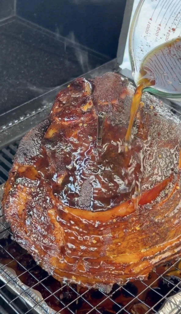 glaze being poured on the ham