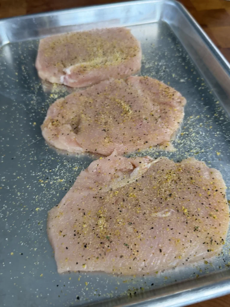 butterflied chicken on a metal tray