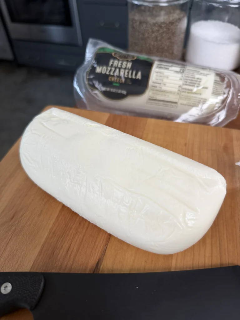 fresh mozarella on a wooden cutting board