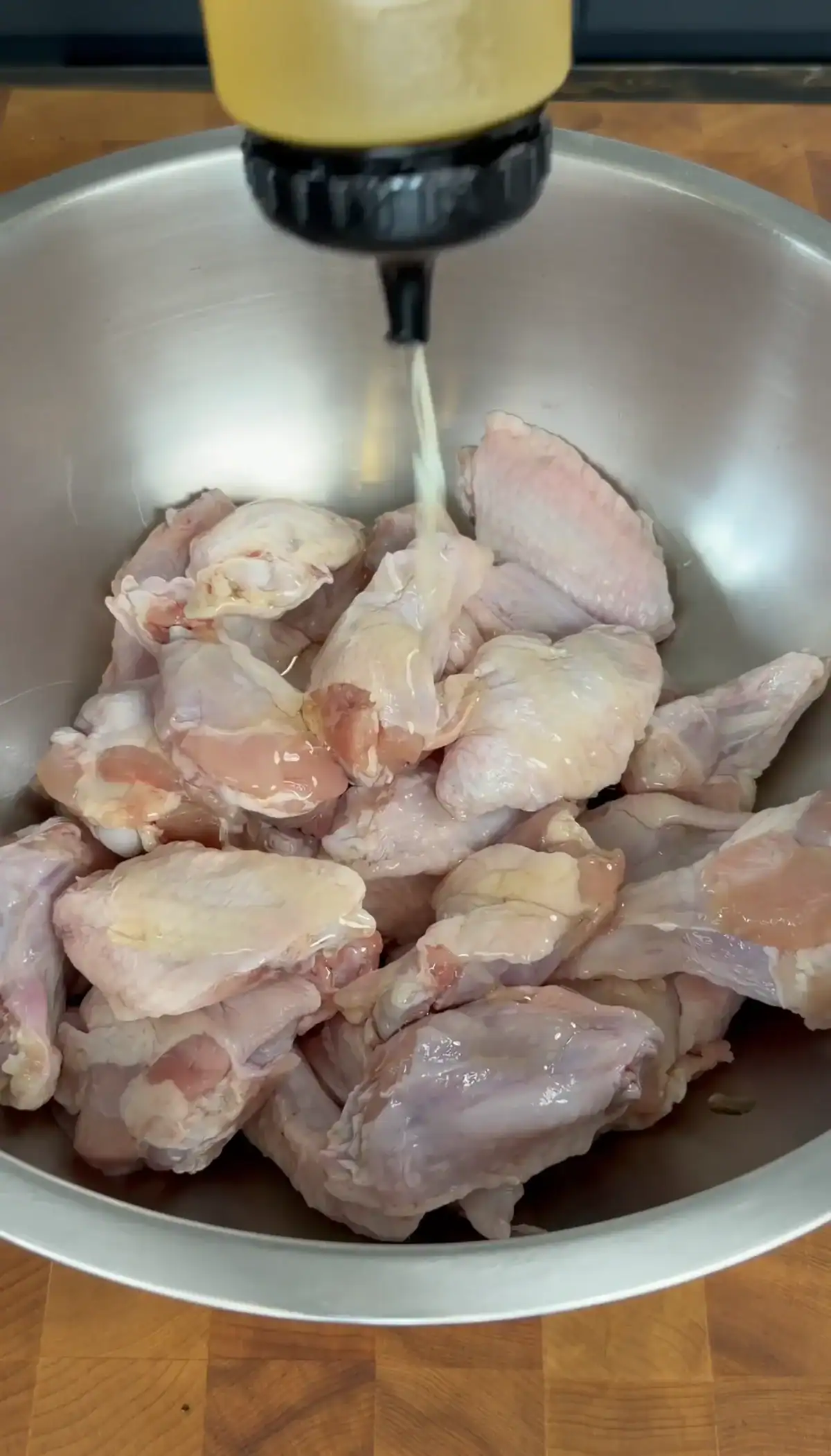 raw chicken wings in a metal bowl