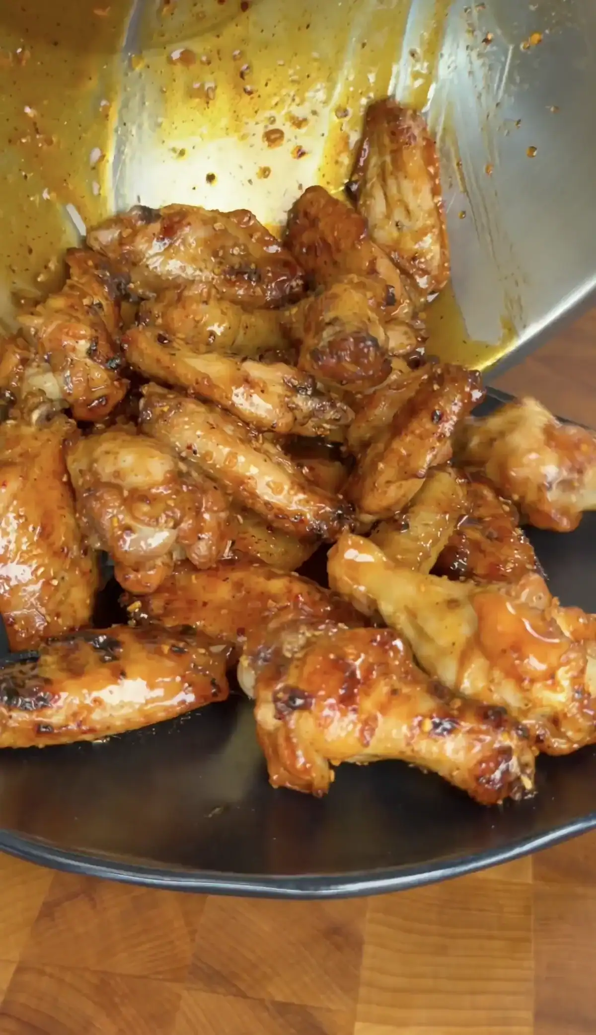 saucy chicken wings in a bowl