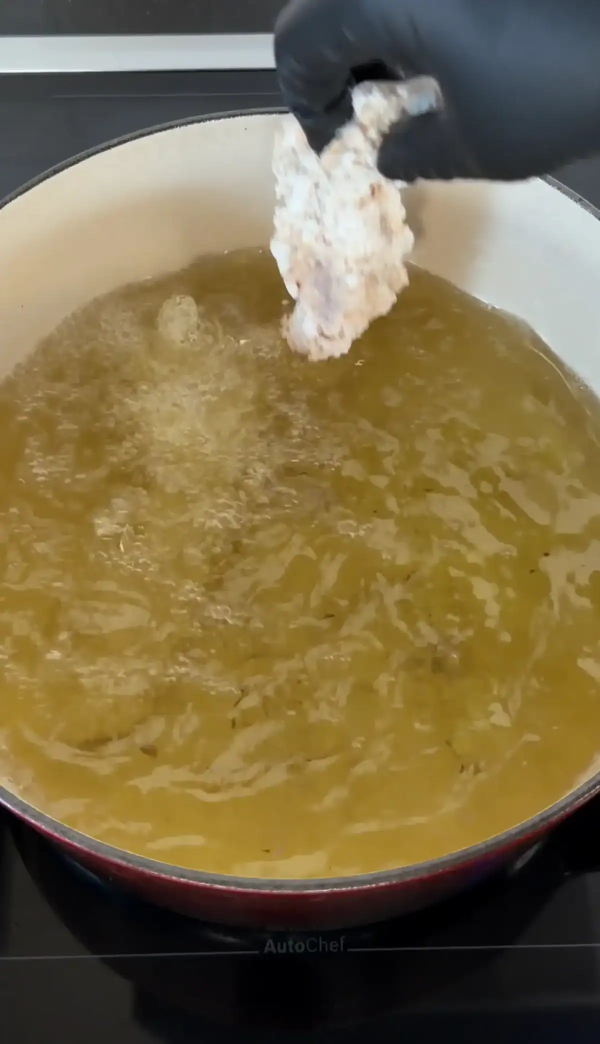 adding chicken to the hot oil