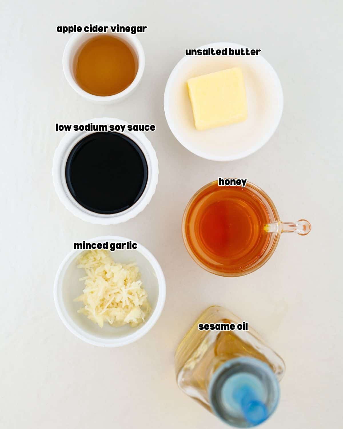 ingredients for honey garlic sauce for chicken wings placed in bowls on a kitchen countertop.