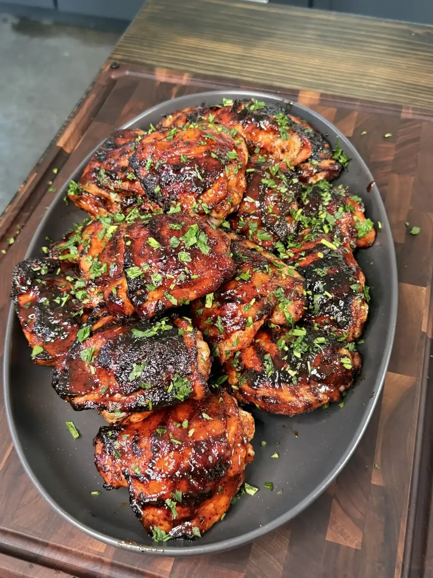 Close-up of crispy charred skin on a grilled chili lime chicken thigh showing golden caramelized edges