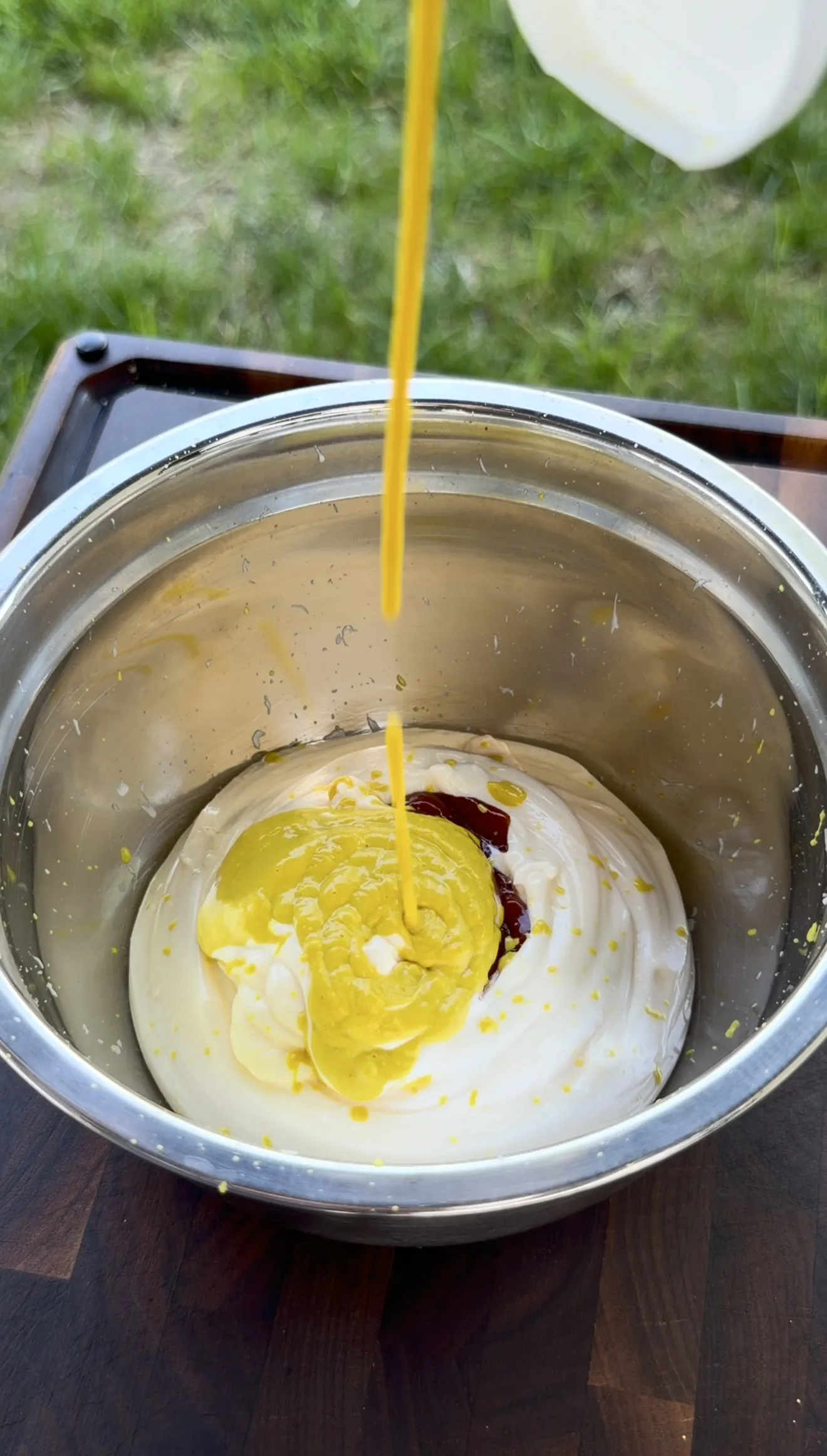 Oklahoma onion burger sauce being mixed in a bowl with yellow mustard and smoked paprika