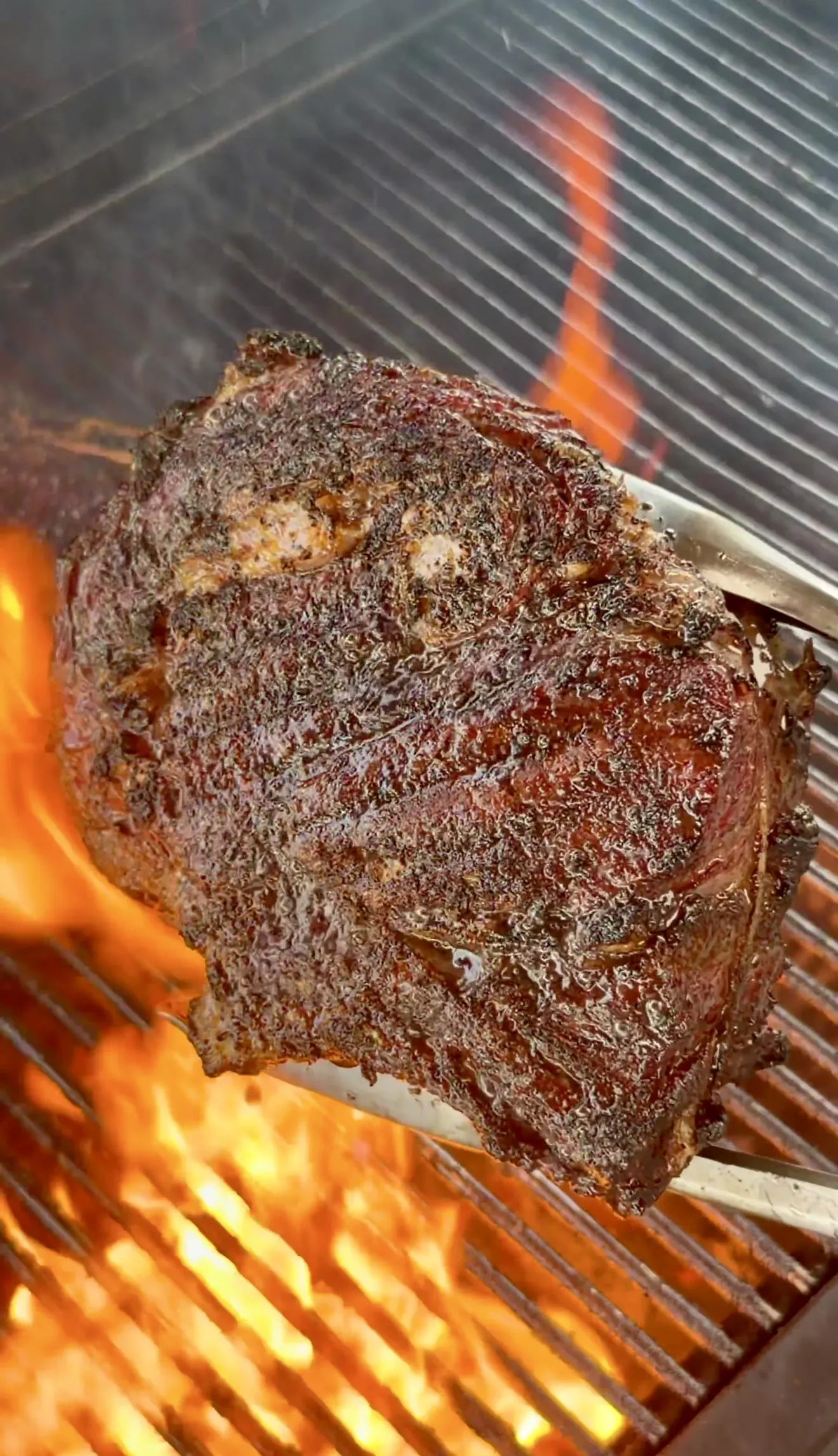 Close-up of grilled steak with whiskey butter glaze on grill grates