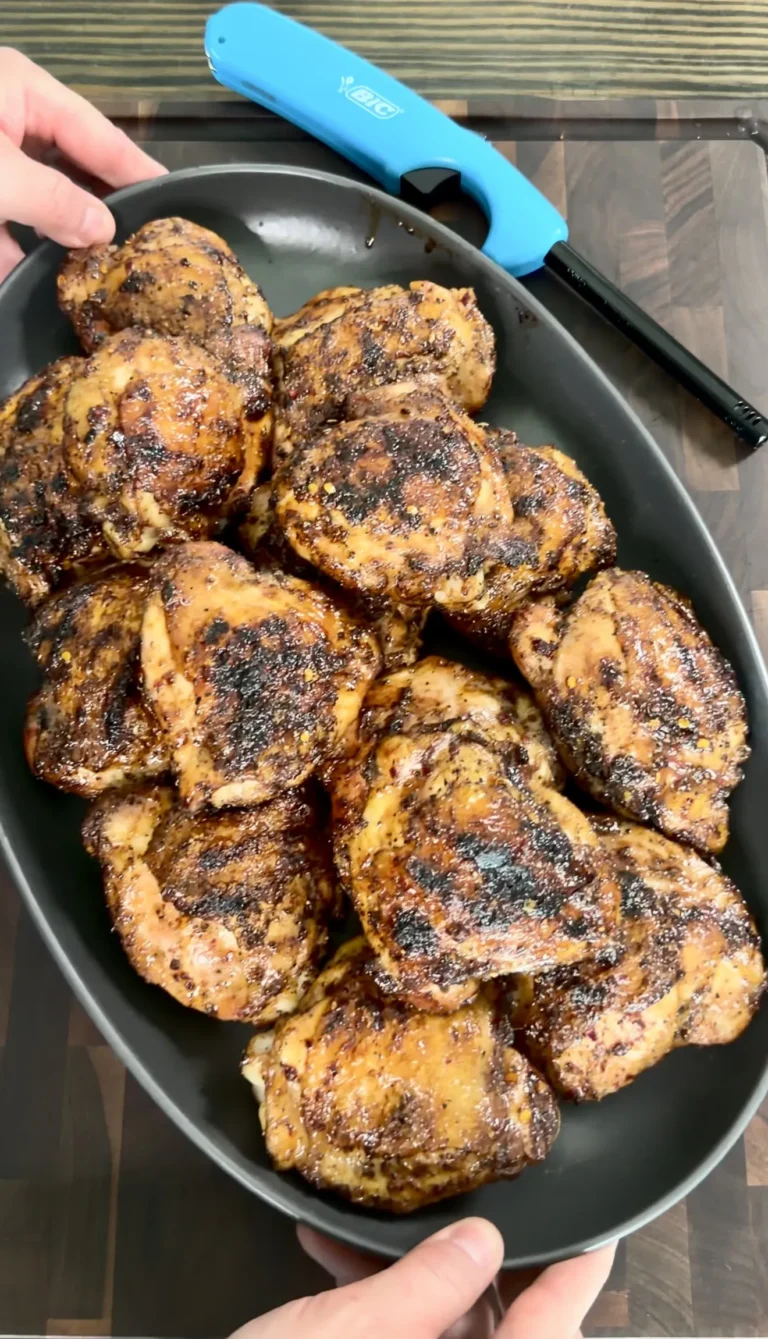 Golden brown honey chili crisp grilled chicken thighs with caramelized coating in a black skillet