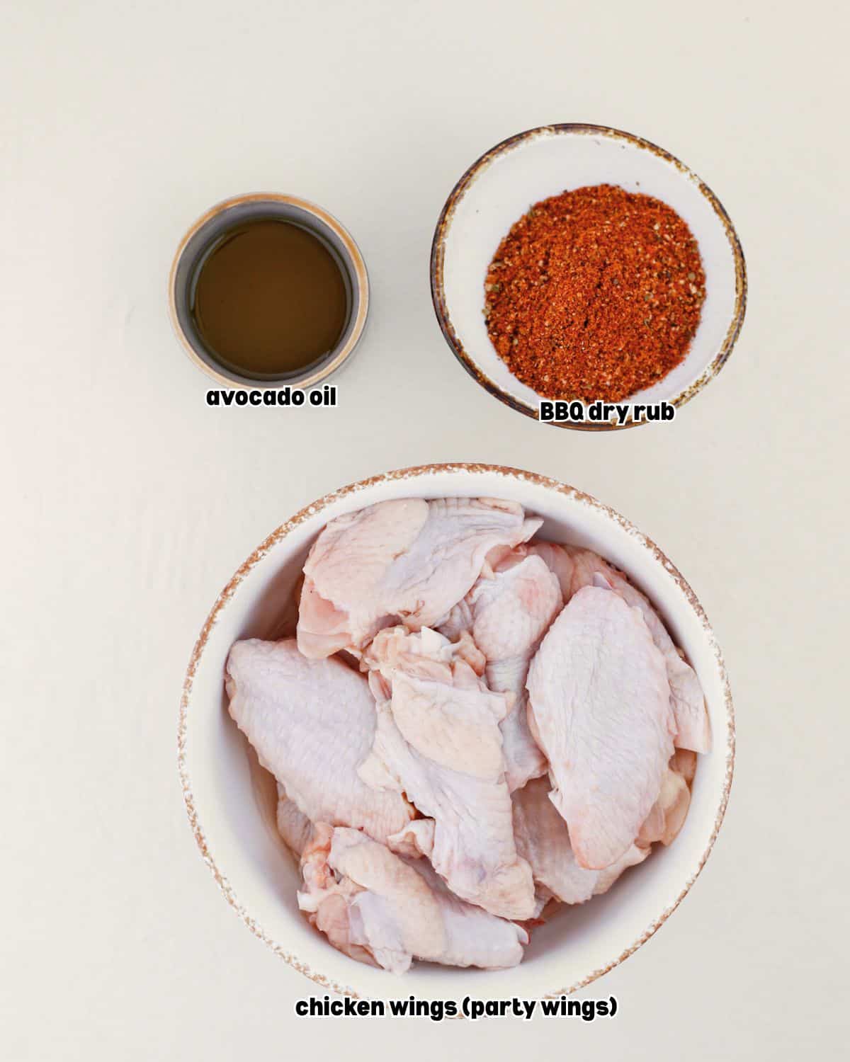 pellet smoked chicken wings ingredients in bowls, placed on a kitchen countertop.