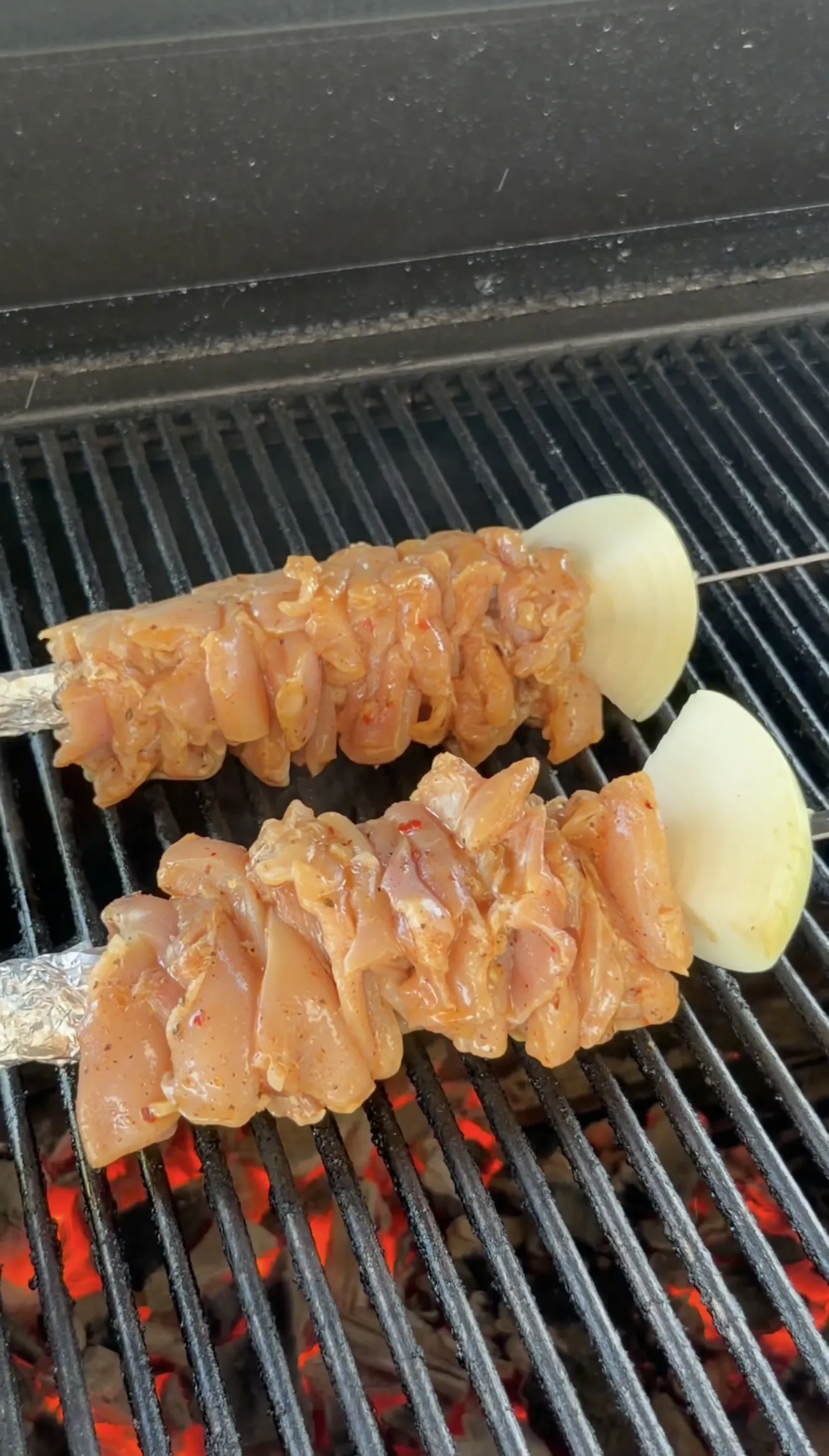 Marinated chicken skewers grilling on BBQ grates at 450 to 500 degrees